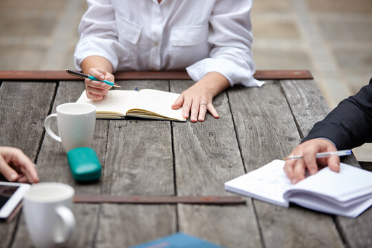 Woman working on table outdoors with team