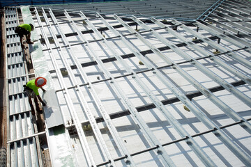 Construction workers with metal framework on an industrial building site