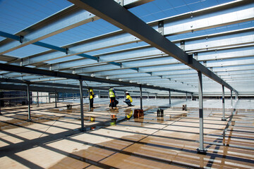 Metal framework and workers on an industrial building site