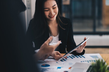Fototapeta premium Asian business adviser meeting to analyze and discuss the situation on the financial report in the meeting room.Investment Consultant,Financial Consultant,Financial advisor and accounting concept.