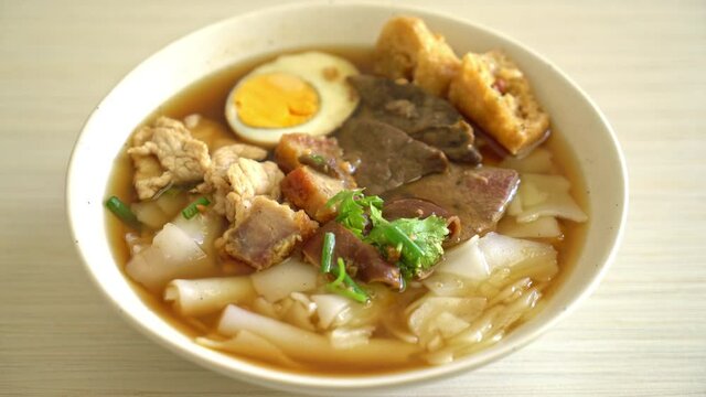 paste of rice flour or boiled Chinese pasta square with pork in brown soup