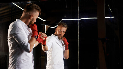 A stylish guy in a shirt is boxing..