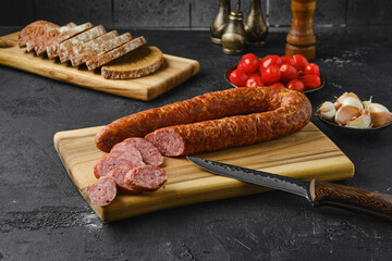 Smoked beef sausage rings on wooden cutting board