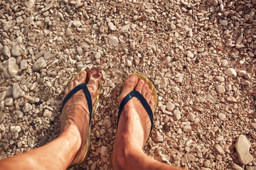 Man sunbathing on a rocky sea ocean beach.