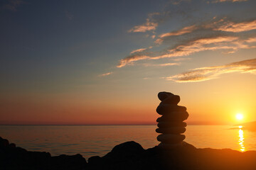Zen stones on a ocean sea cliff in sunset sunrise time.
