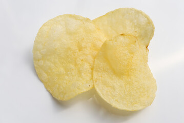 crispy potato chips on white background.