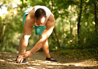 Fototapeta premium Young man making exercises outdoors.