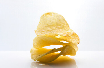 crispy potato chips on white background.