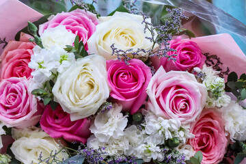 Close up  pink rose bouquet decorative with colorful gypsophila , top view gift background