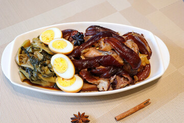 Top view of Pa lo or Belly pork stew chinese style with boiled eggs served with pickled lettuces very famous in Thailand street food as well.