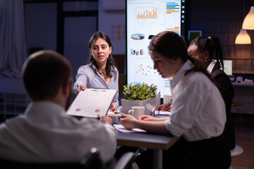 Executive manager woman explaining management statistics working at company strategy overtime in...