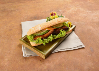 cook kong bak bao asian braised pork belly with vegetables in long focaccia bread and flower salad on wood table asian traditional pastry sandwich menu