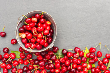 Fresh crop of cherry berries on a stone gray countertop.