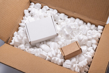 Cardboard box on loose white Filler Shipping Packing Peanuts