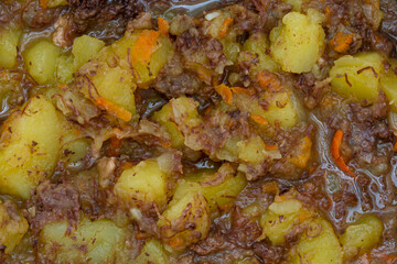Potatoes with bear stew. Close-up. Abstract background for design and project.