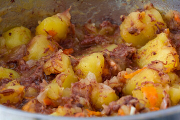 Potatoes with bear stew. Close-up. Stewed potatoes with meat. Cooking concept.