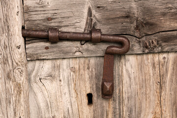 Old sliding bolt lock on antique wooden door