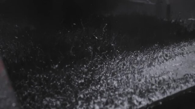 Oil rig shale shaker separating cuttings from drilling mud in slow motion