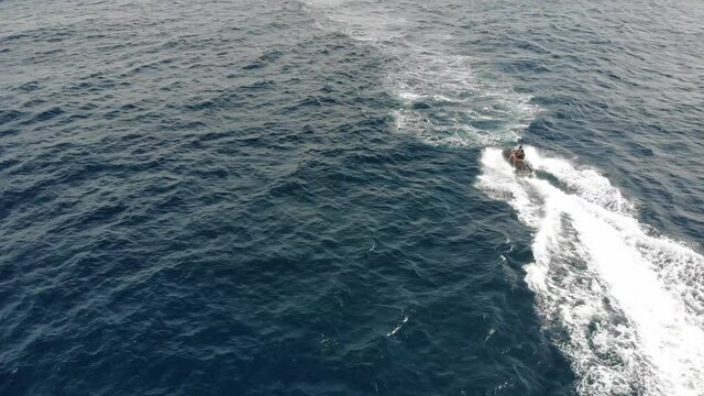 Aerial view of a hydrocycle in a deep blue colored sea	