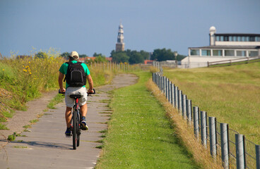 Man cycling in the Netherlands during vacation (Hindeloopen, Frisia)