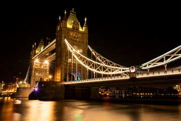 tower bridge with lights on at dark night