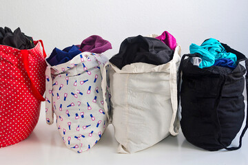 Reusable cloth bags filled with clothes
