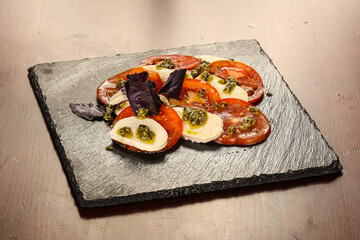 Italian caprese salad with mozzarella and cheese