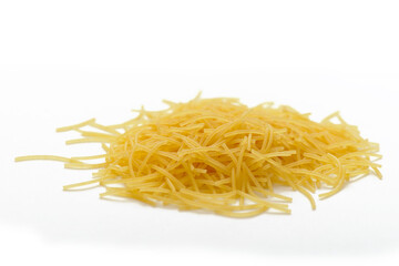 A small pile of yellow short pasta, vermicelli on a white background - obrazy, fototapety, plakaty