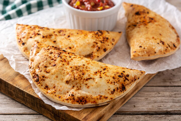 Traditional Chilean empanadas on rustic wooden table