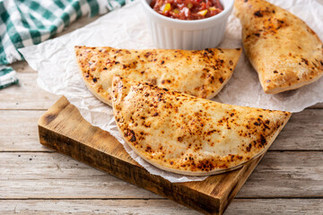 Traditional Chilean empanadas on rustic wooden table