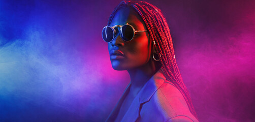 colorful neon filtered shot of a beautiful young afro woman posing in the studio