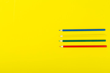 school supplies on a yellow background, top view