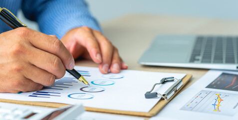 Close up account man hand using calculator for calculate and writing make a note with pen, ..financial reporting and business performance to check investment results