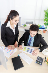 Asian businessman and businesswoman working together in office. Concept for teamwork in company