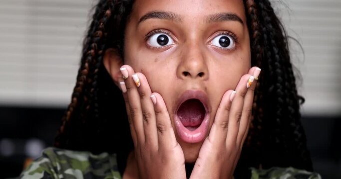 Excited child shocking reaction. girl reacts with surprise with open mouth