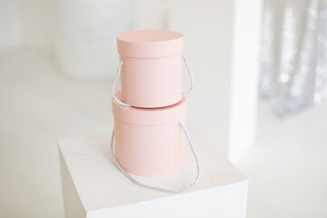 Two pink round boxes on a white background 