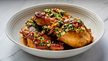 Thai Oyster chicken grilled with spicy sauce, cilantro, lime juice, red and green chillis.