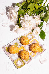 Profiteroles with blueberries. Custard cakes, Eclair, cream puff on a wooden stand