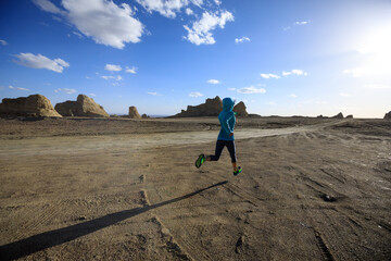 Fitness woman trail runner cross country running  on sand desert