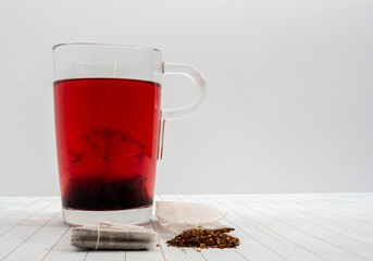 Fruit tea in a paper bag and a cup of tea.