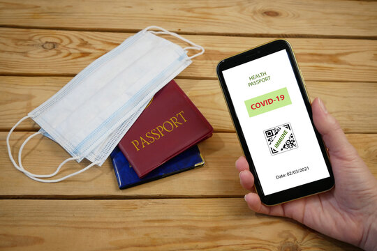 Vaccination passport on a mobile phone allowing travel in hand. Vaccination against the coronavirus Covid 19.Imunity or Health passport