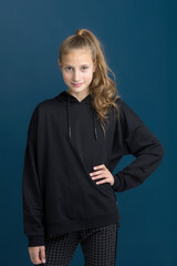 Pretty teenage girl in black hoodie.