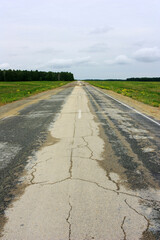 Empty asphalt road in green field