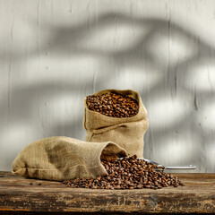 Coffee beans in sacks and wall with shadows 