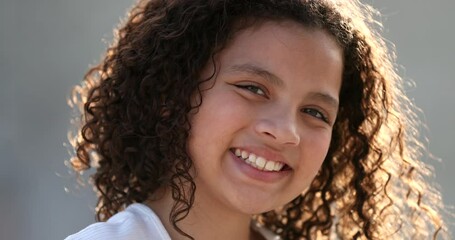 HIspanic little girl child portrait face close-up smiling outside - Powered by Adobe