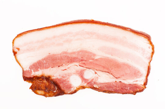 Pieces of smoked bacon on white background