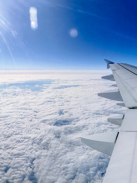 Magnificent view of the horizon and top of the clouds, airplane wing, photo taken in flight