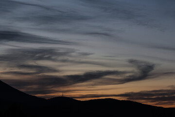 sunset sky with pink and orange clouds over the mountains