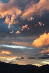 sunset sky with pink and orange clouds over the mountains