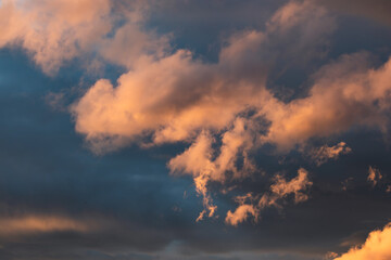 sunset sky with pink and orange clouds over the mountains